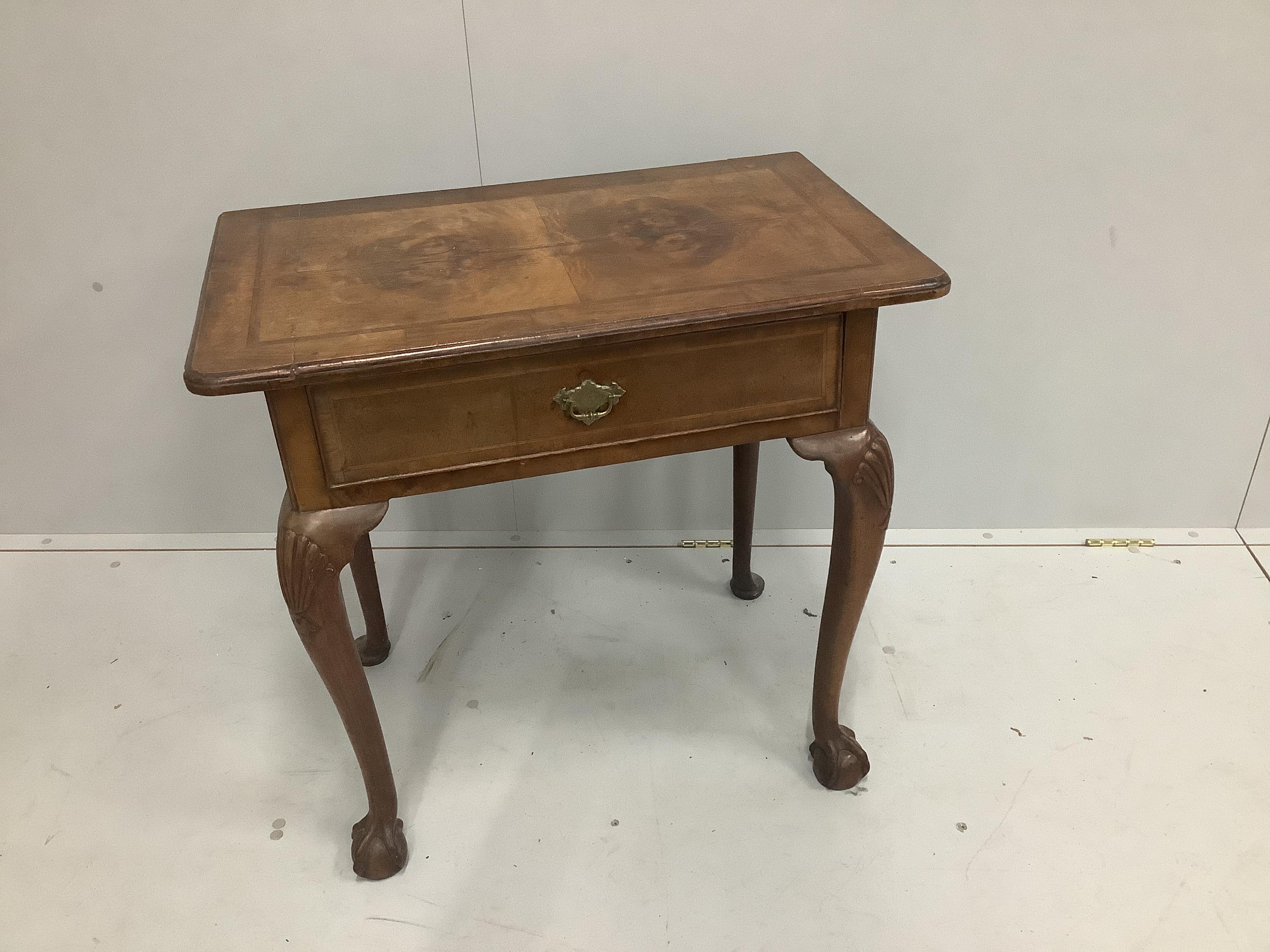 An early 18th century and later featherbanded walnut lowboy, with single frieze drawer, raised on carved cabriole legs with claw and ball feet, width 75cm, depth 45cm, height 70cm